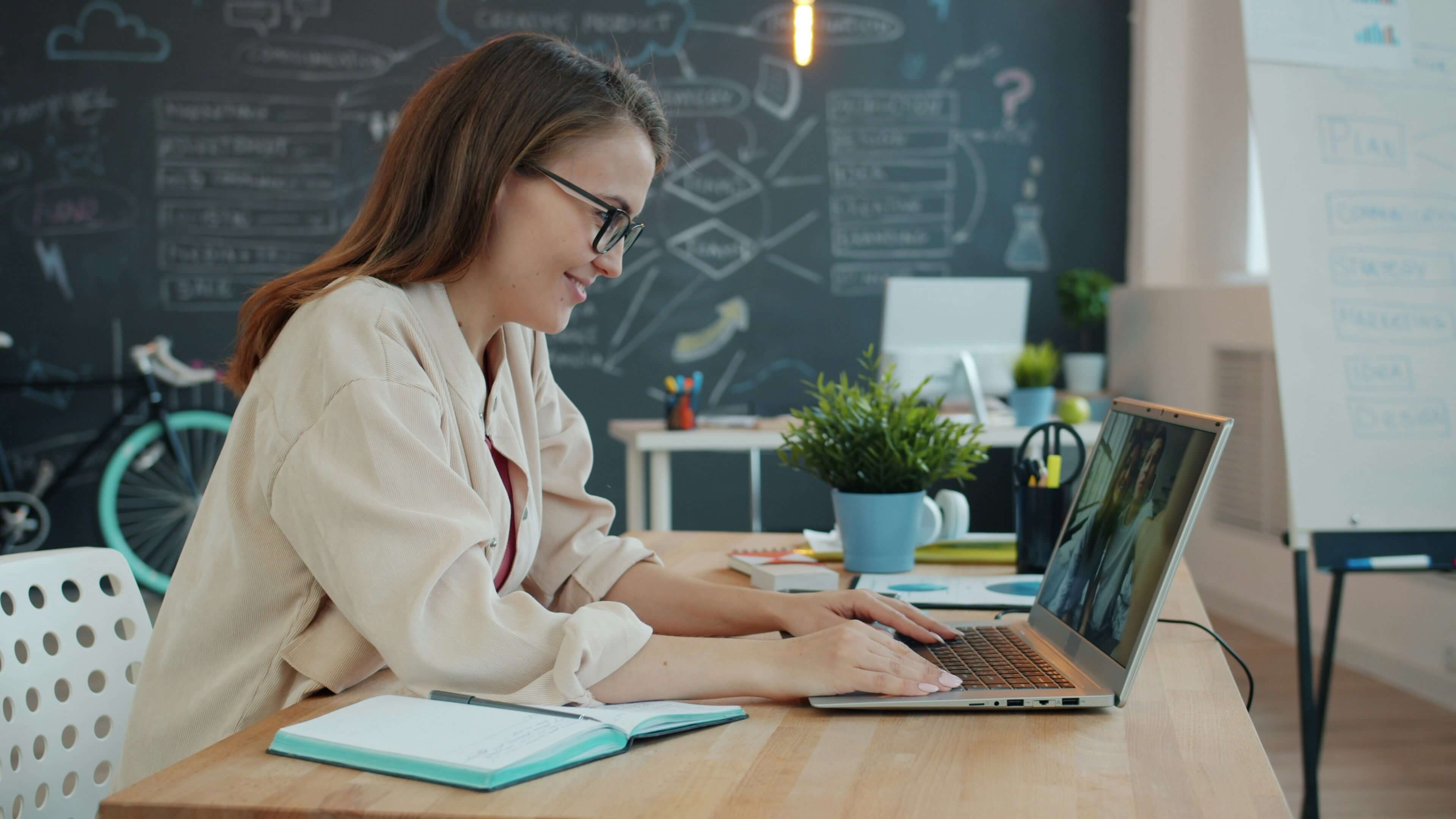 Modern software workspace with laptop showing subscription tools for productivity and design
